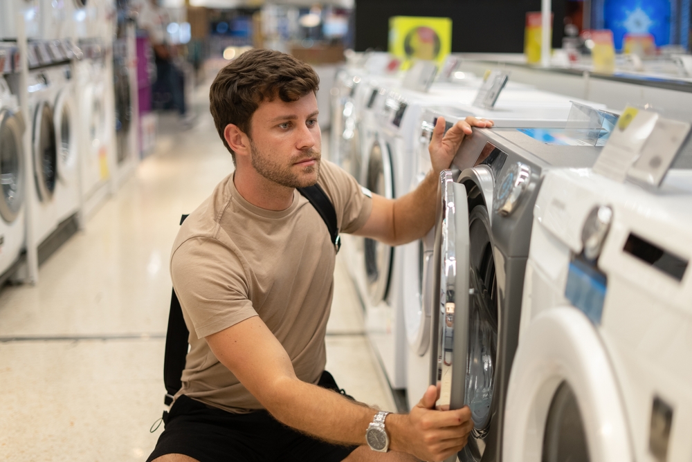 Energy label washing machine man choosing washing machine