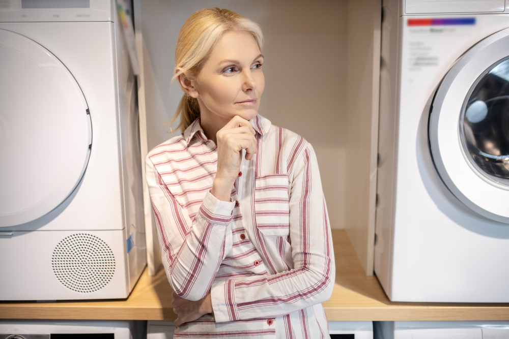 Heat pump dryer with steam function woman thinking