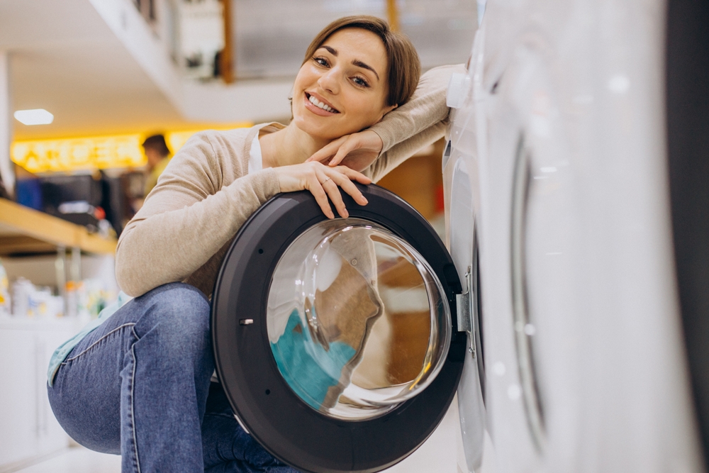 Self cleaning heat pump dryer woman in the store