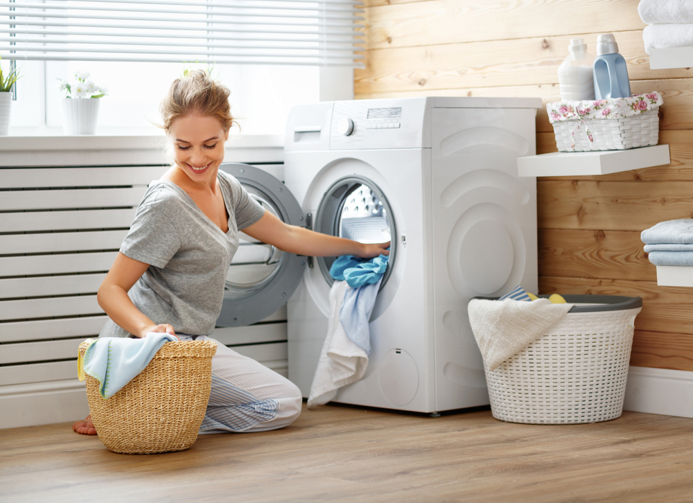 Washer dryer combo experiences woman loading washer dryer combo 1