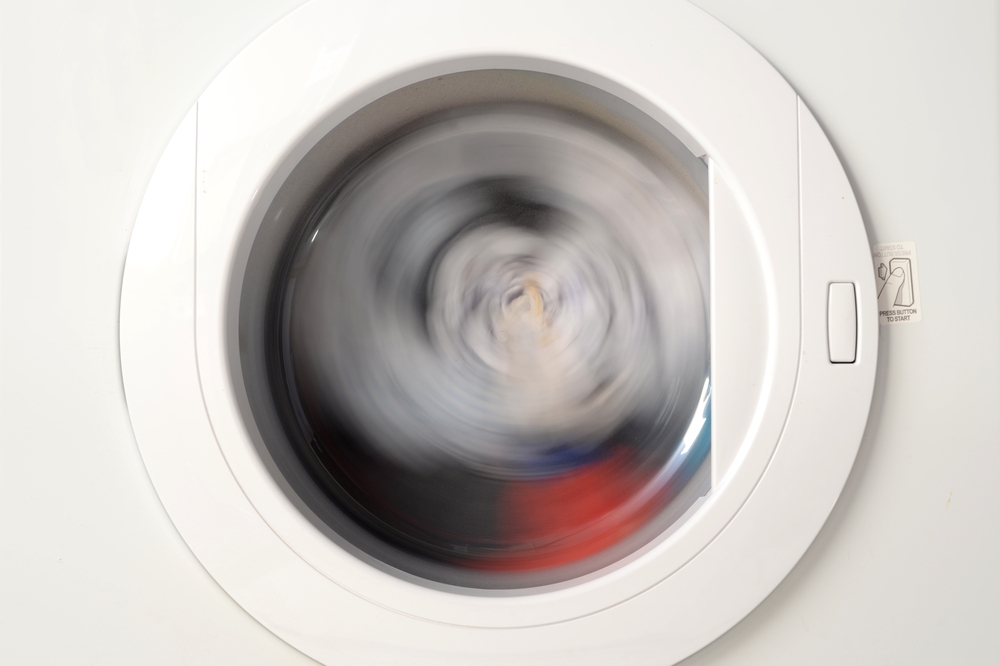 Washing machine spinning clothes in the drum