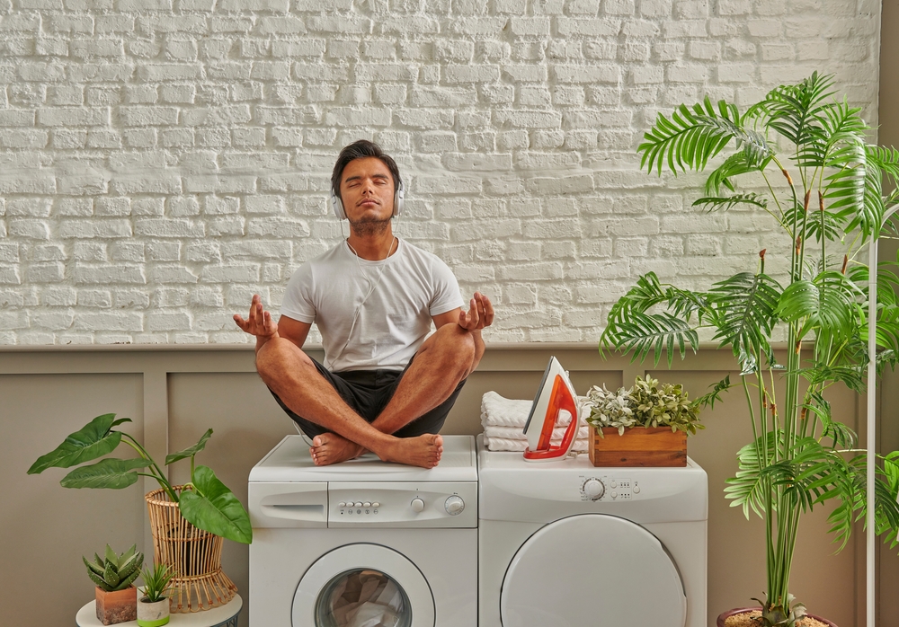 Whirlpool heat pump dryer man relaxing in the laundry